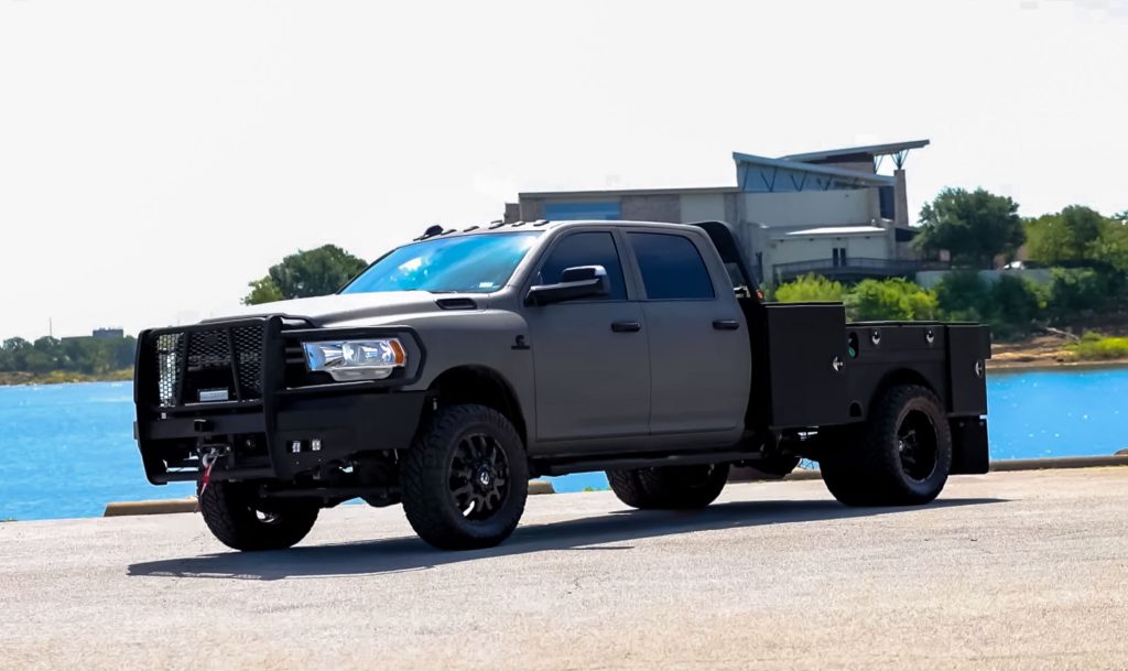 Side view of custom Dodge Ram 3500 flatbed featuring Apex Signature Finish exterior coating and heavy-duty utility bed installed by Apex Custom Innovations