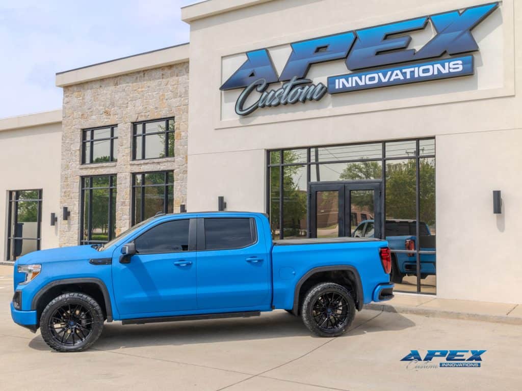 Side profile of 2022 GMC Sierra 1500 with Voodoo Blue Apex Armor, TIS wheels, Toyo tires, and AMP Research power running boards