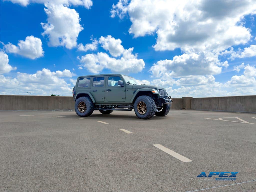 Rooftop side profile of 2025 Jeep Wrangler Rubicon 392 with Sarge Green Apex Armor, bronze wheels, and oversized tires
